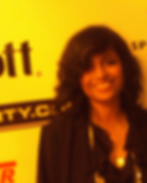 Blurry photo: soft, unfocused edges across a face and a yellow backdrop